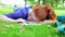 Pretty young student lying on the grass asleep