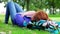 Pretty young student lying on the grass on her bookbag