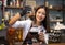 Pretty young woman caucasian barista prepare coffee Syphon Stir