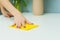 A pretty young woman is cleaning her house and doing a wet cleaning. Close-up of a girl`s hand wiping dust