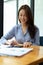 Pretty young woman company employee using smartphone at workspace