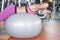 Pretty young woman doing exercise using exercise ball