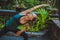 Pretty young woman doing yoga outside in natural environment