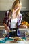 Pretty young woman dressing quinoa salad in the kitchen at home.