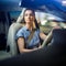 Pretty, young woman driving a car