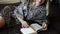 Pretty young woman enjoying reading a book at home lying on bed smiling in pleasure in dressing gown