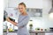 Pretty, young woman in her modern kitchen