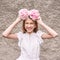 Pretty young woman holding peony bloom like wreath