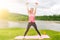 Pretty young woman lifting small weights dumbbells in the park