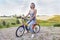 Pretty young woman on little bike