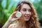 Pretty young woman with long hair holding a bar of soap