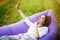 Pretty young woman lying on inflatable sofa lamzac take selfie on phone while resting on grass in park on the sun