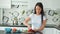 Pretty young woman prepares lunch and shreds green cucumber for salad with sharp knife