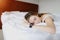 Pretty young woman sleeping uses Smartwatch with accurate sleep tracking