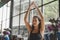 Pretty young woman slim body doing yoga in Padmasana or Lotus yoga pose on yoga mat with instructor in class at fitness gym