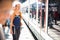 Pretty, young woman in a trainstation, waiting for her train