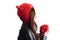 Pretty young woman wearing a hand knitted red hat on white background. Isolated. Beautiful girl in with Ear flap.