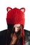 Pretty young woman wearing a hand knitted red hat on white background. Isolated. Beautiful girl in with Ear flap.