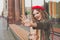 Pretty young woman wearing red french beret waving hello