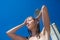 Pretty, young woman woman under shower on the beach