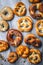 pretzels baked pastry with various toppings on a marble table