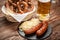 Pretzels, bratwurst and sauerkraut on wooden table