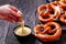 Pretzels in the form of knot with cheese sauce