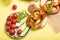 Pretzels and vegetables on yellow background, german traditional food, bavarian snack, european breakfast, oktoberfest