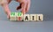 Prevail or fail symbol. Concept words Prevail or Fail on wooden cubes. Businessman hand. Beautiful grey table grey background.