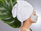 Preventing breakouts one mask at a time. an attractive young woman wearing a face mask and posing with a monstera leaf