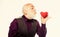Preventing heart attack. Fall in love. Heartbeat diagnostics and treatment. Health care. Senior bald head bearded man