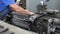 Prevention and maintenance of machine tools in the machine shop. A worker in overalls sets up a lathe to work with metal