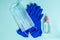 Preventive protection against coronavirus. Latex gloves, medical face mask and antiseptic on a blue background