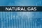 Price change on Natural gas futures ticker NG in world on blue financial background from numbers, graphs, pillars, candles.