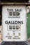 The price of petrol. Vintage car fuel meter priced in shillings