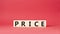 Price symbol. Wooden cubes with word Price. Beautiful red background. Price concept. Copy space