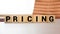 Pricing Word Written In Wooden Cube, concept