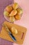 Prickly pears in a plate with cutting board, knife top view on pink and picnic cloth background