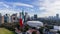 Pride in the Breeze: Massive Mexican Flag Soars Over Mexico City, Framed by Urban Splendor and Majestic Mountains