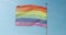 Pride flag - Close up view. Official LGBT flag. . Blue sky on the background