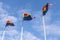 Pride flags waving against blue sky