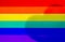 Pride or rainbow flag made from colorful paper with shadow of love shape