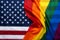 Pride rainbow lgbt gay flag over American US flag . Equality diversity freedom in USA