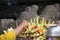 A priest arranging the decoration of worship serving ritual of hindu god and goddess in a sacred temple in Bali