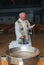 A priest blesses the oils during a child`s baptism