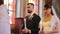 Priest blesses a young wedding couple at a wedding ceremony in a beautiful church. Focused groom in a suit and bride in