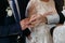 The priest changes the wedding rings on the fingers of the bride and groom.