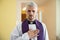 Priest cleric praying with his hand on heart