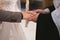 The priest consecrates the wedding rings on the fingers of the bride and groom. Wedding tradition and ritual. hands of a