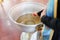 the priest dips the brush into Baptismal font in the Orthodox Church.